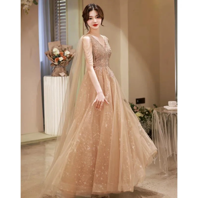 Sparkling Beige Gown With Sheer Cape Design